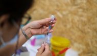A healthcare worker prepares a dose of the Pfizer coronavirus disease (COVID-19) vaccine at a vaccination centre in Seixal, Portugal, September 11, 2021. Picture taken September 11, 2021. REUTERS/Pedro Nunes
