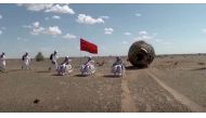 A screen grab shows Chinese astronauts posing for photos after their 90-day mission to a space station, in China's Inner Mongolia Autonomous Region, September 17, 2021. Reuters TV/China Central Television (CCTV) via REUTERS 