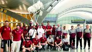 Qatar volleyball players and officials posing for a photograph upon their arrival at the Hamad International Airport in Doha, yesterday.