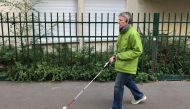 Laurence Jamet, Parisian woman blind since birth, walks with a cane and the electronic device, called Rango, invented by the Lyon-based startup Gosense, which uses sound and augmented reality to warn visually impaired people before a collision can occur, 