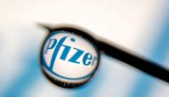 Pfizer logo is reflected in a drop on a syringe needle in this illustration photo taken March 16, 2021. REUTERS/Dado Ruvic/Illustration/File Photo/File Photo