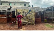 FILE PHOTO: Artist and bronze caster Osarobo Zeickner-Okoro is seen in front of a newly unveiled plaque that he is offering to the British Museum as a gift, in Benin City, Nigeria, July 31, 2021. Picture taken July 31, 2021. REUTERS/Tife Owolabi/File Phot