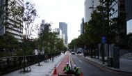 People work on an empty street in Seoul, South Korea, September 30, 2021. REUTERS/Kim Hong-Ji