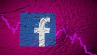 Facebook logo and stock graph are displayed through broken glass in this illustration taken October 4, 2021. (REUTERS/Dado Ruvic/Illustration)