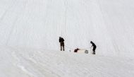 Team members Erik Huss and Oskar Kihlborg check for cracks on Helags glacier, in Sweden, June 23, 2021. Picture taken June 23, 2021. Anders Klapp/Handout via REUTERS