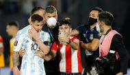 A pitch invader with Argentina's Lionel Messi after a match. (REUTERS/Cesar Olmedo)