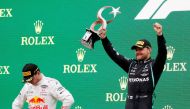 Mercedes' Valtteri Bottas celebrates with the trophy on the podium after winning the race alongside second placed Red Bull's Max Verstappen REUTERS/Murad Sezer 