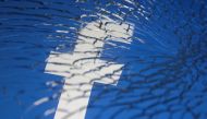 Facebook logo displayed through broken glass. (File Pic/REUTERS/Dado Ruvic)