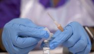 A medical worker prepares an injection with a dose of Astra Zeneca coronavirus vaccine, at a vaccination centre in Baitul Futuh Mosque, amid the outbreak of coronavirus disease (COVID-19), in London, Britain, March 28, 2021. REUTERS/Henry Nicholls/File Ph