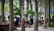 People rest as they keep social distancing to avoid the spread of the coronavirus disease (COVID-19) at a park in Seoul, South Korea, September 27, 2021. REUTERS/Kim Hong-Ji
