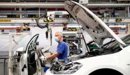 A worker wears a protective mask at the Volkswagen assembly line after VW re-starts Europe's largest car factory after coronavirus shutdown in Wolfsburg, Germany, April 27, 2020, as the spread of the coronavirus disease (COVID-19) continues. Swen Pfoertne
