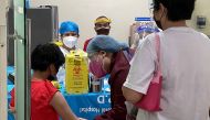 A health worker prepares to inoculate a child with Pfizer-BioNTech vaccine against the coronavirus disease (COVID-19), during the vaccine rollout for children with comorbidities, in Pasig City, Metro Manila, Philippines, October 15, 2021. PASIG CITY PUBLI