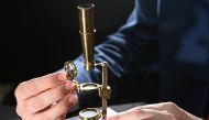 James Hyslop, Head of Scientific Instruments, Globes and Natural History at Christie's, demonstrates the Darwin Family Microscope, owned and used by the English naturalist and founder of the concept of evolution, Charles Darwin, which will be offered at a