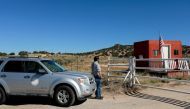 A compliance officer from the State of New Mexico waits to enter Bonanza Creek Ranch where on the film set of 