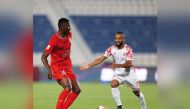 Al Duhail's Michael Olunga vies for the ball with an Al Shamal player.