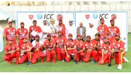Bahrain players and officials celebrate with the champions' trophy after securing a place in one of the global qualifiers, yesterday. Pictures: Abdul Basit / The Peninsula 