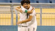 Al Sadd's captain Hassan Al Haydos congratulates Baghdad Bounedjah after the Algerian scored his second goal yesterday.