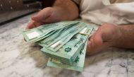 Antoine Haddad, known as Abou Chadi, a Lebanese restaurant owner, holds Lebanese pound banknotes in Jal el-Dib, Lebanon October 26, 2021. Picture taken October 26, 2021. REUTERS/Issam Abdallah