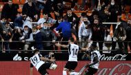 Valencia's Hugo Duro celebrates scoring their third goal with Jose Gaya and Mouctar Diakhaby REUTERS/Pablo Morano
