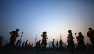 Participants run on the Bund near Huangpu River as they compete in the Shanghai International Marathon December 1, 2013. REUTERS/Carlos Barria