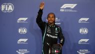 Mercedes' Lewis Hamilton celebrates with the trophy on the podium after finishing first place in qualifying REUTERS/Hamad I Mohammed