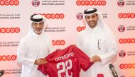 Qatar Football Association President Sheikh Hamad bin Khalifa bin Ahmed Al Thani presents a Qatar team jersey to CEO of Ooredoo Sheikh Mohammed bin Abdulla Al Thani after the sponsorship signing ceremony.