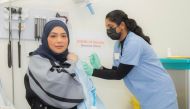 Head of Vaccination at the Ministry of Public Health (MoPH), Dr. Soha Al Bayat receiving her booster dose 