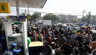People on motorcycles wait for their turn to get petrol at a petrol station, after Pakistan Petroleum Dealers Association (PPDA) announced a countrywide strike, in Karachi, Pakistan, November 25, 2021. REUTERS/Akhtar Soomro

