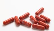 FILE PHOTO: An experimental COVID-19 treatment pill, called molnupiravir and being developed by Merck & Co Inc and Ridgeback Biotherapeutics LP, is seen in this undated handout photo released by Merck & Co Inc and obtained by Reuters on October 26, 2021. Merck & Co Inc/Handout via REUTER