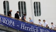 Passengers briefly disembark the MSC Europa cruise ship after docking to South African waters, as the new coronavirus variant Omicron spreads, in Cape Town, South Africa, November 30, 2021. REUTERS/Shelley Christians
