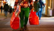 A man carries bags on Hohe Strasse shopping street as the spread of the coronavirus disease (COVID-19) continues in Cologne, Germany, December 1, 2021. REUTERS