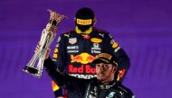 Mercedes' Lewis Hamilton celebrates with the trophy on the podium after winning the race as second placed Red Bull's Max Verstappen looks dejected REUTERS/Hamad I Mohammed TPX IMAGES OF THE DAY
