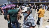 People wait outside a vaccination centre, amid the coronavirus disease (COVID-19) pandemic in Limassol, Cyprus May 4, 2021. REUTERS/Yiannis Kourtoglou
