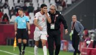 Tunisia coach Mondher El Khabir gives instructions to Mohamed Amine Ben Hamida.