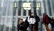 FILE PHOTO: People leave the Apple Store on Fifth Avenue on Black Friday in the Manhattan borough of New York City, New York, U.S., November 26, 2021. REUTERS/Carlo Allegri/File Photo
