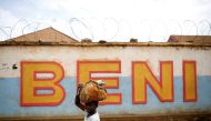 A Congolese boy walks past a wall near the Alima Ebola treatment centre in Beni, in the Democratic Republic of Congo, April 1, 2019. Picture taken April 1, 2019.REUTERS/Baz Ratner/File Photo