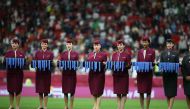 Qatar Airways hostesses carry the FIFA Arab Cup medals following final match between Tunisia and Algeria at Al Bayt Stadium, on Saturday.