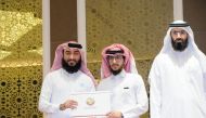 Director of Department of Religious Call and Guidance Mal Allah Abdulrahman Al Jaber honouring an imam at the department headquarters, yesterday.