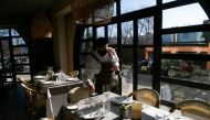 A waiter sets a table at La Querida restaurant in Pozuelo de Alarcon, Madrid, Spain December 28, 2021. Picture taken December 28, 2021. REUTERS/Javier Barbancho

