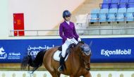 Maryam Ahmad Al Boinin astride Vol De Nuit Tardonne during the Dressage, Preliminary (Level 2) - Test 2C event in the third round of the Longines Hathab Qatar Equestrian Tour at Qatar Equestrian Federation's (QEF) Indoor Arena, yesterday. 