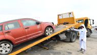 An abandoned vehicle is being removed in Al Rayan.