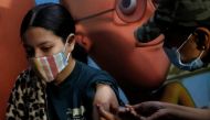 A girl receives a dose of the COVAXIN coronavirus disease (COVID-19) vaccine manufactured by Bharat Biotech, during a vaccination drive for children aged 15-18 in New Delhi, India, January 3, 2022. REUTERS/Adnan Abidi