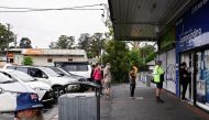 Customers queue outside a Western Sydney chemist to purchase Rapid Antigen Test kits in the wake of the coronavirus disease (COVID-19) pandemic in Sydney, Australia, January 5, 2022. REUTERS/Jaimi Joy REFILE- CORRECTING YEAR