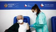 A man receives a dose of the Moderna vaccine against the coronavirus disease (COVID-19), on the day the government is expected to approve new rules for schools and COVID-19 vaccination for workers, at the Music Auditorium in Rome, Italy, January 5, 2022. REUTERS/Guglielmo Mangiapane

