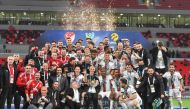 Besiktas players and officials celebrate with the trophy.