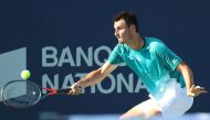 Bernard Tomic from Australia hits a shot against Roberto Bautista Agut from Spain (not pictured) during the Rogers Cup tennis tournament at Stade IGA. Mandatory Credit: Jean-Yves Ahern-USA TODAY Sports

