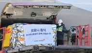 A worker unloads a cargo containing Pfizer's antiviral pill, Paxlovid at a cargo terminal of the Incheon International Airport, in Seoul, South Korea January 13, 2022. Jung Yeon-je /Pool via Reuters