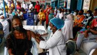 Aminata Laye Diagne, a nurse gives a dose of coronavirus disease (COVID-19) vaccine to a woman at Philippe Senghor Hospital in Dakar, amid a surge of coronavirus disease (COVID-19) cases in Senegal July 28, 2021. REUTERS/Zohra Bensemra/File Photo