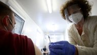  A doctor vaccinates a person with a dose of the Pfizer-BioNTech COVID-19 vaccine in Vienna, Austria April 26, 2021. REUTERS/Lisi Niesner/File Photo