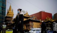 People wearing protective masks walk on a street, following new cases of the coronavirus disease (COVID-19), in Shanghai, China January 17, 2022. REUTERS/Aly Song